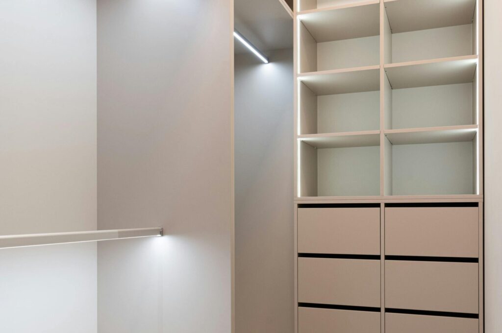 Elegant and spacious modern walk-in closet with ample storage and minimalist design.